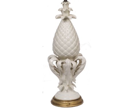 A WHITE GLAZED POTTERY TABLE LAMP in the form of a pineapple on a turned gilt wood socle, the lamp base 62cm high overall