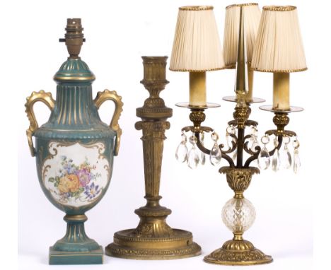 A CAST GILT METAL TABLE LAMP in the 18th century French style, 40cm high together with a porcelain table lamp in the form of 