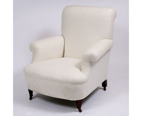 A LATE VICTORIAN OR EDWARDIAN ARMCHAIR with scrolling arms, turned tapering front legs terminating in ceramic casters, 84cm w