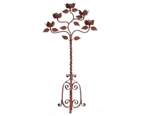 A WROUGHT IRON FIVE BRANCH FLOOR STANDING CANDLE STAND with rose flower decoration and on a scrolling tripod base 70cm wide x