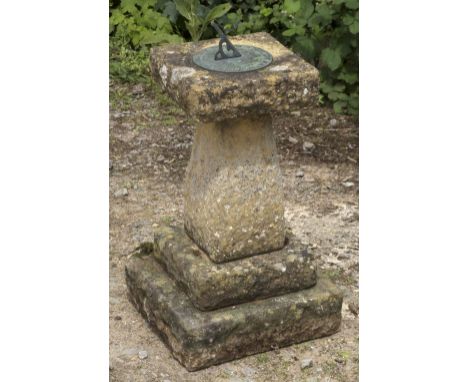 A 20TH CENTURY RECONSTITUTED STONE SUNDIAL on square base standing on spreading plinth, the dial inscribed 'Tyme hyes' 31cm x