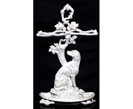 A WHITE PAINTED CAST IRON STICK STAND in the manner of Colebrookdale with oak branch decoration and supported by a seated hou