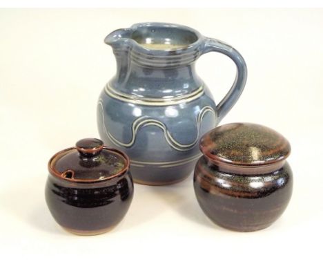 WINCHCOMBE POTTERY. A Winchcombe two pint jug &amp; two lidded pots by Sidney Tustin.