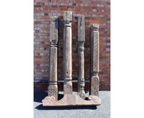 A SELECTION BELIEVED LAST QUARTER 19TH CENTURY INDIAN CARVED WOODEN ARCHITECTURAL SECTIONS, comprising four columns and one c