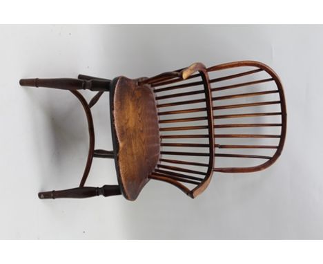 A LATE 19TH CENTURY COUNTRY STICK BACK ARMCHAIR with partial yew wood frame and elm seat, on ring turned fore supports with c