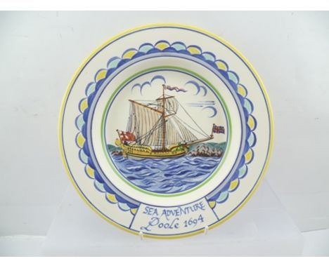A MID 20TH CENTURY POOLE POTTERY PLATE, decorated with a hand painted sailing ship, inscribed to the edge "Sea Adventure Pool