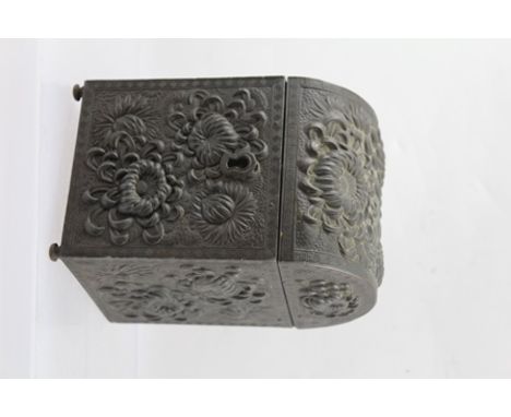A JAPANESE BRONZED METAL TEA CADDY of domed casket form, cast with floral decoration, the cover opening to reveal a wooden in