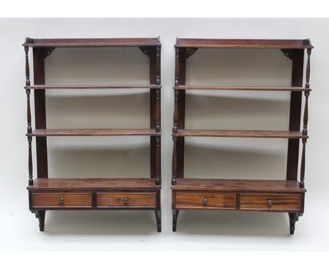 A PAIR OF EDWARDIAN MAHOGANY WALL SHELF UNITS with fine turned decoration, fitted two small drawers to the base with knob han