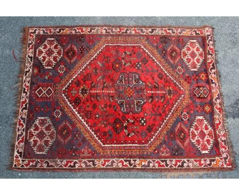 A 20TH CENTURY CAUCASIAN CARPET, red central diamond with stylised motifs, bordered, 145cm x 186cm 