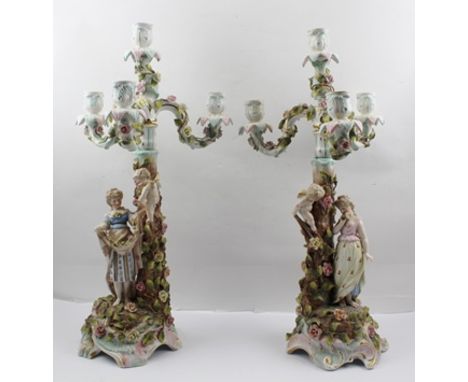 A PAIR OF LATE 19TH CENTURY SITZENDORF PORCELAIN CANDELABRA, each base fitted with a triple branch top, all-over floral encru