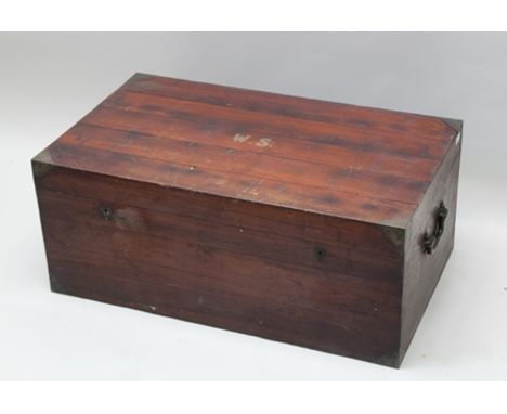 AN ANGLO-INDIAN HARDWOOD CAMPAIGN STYLE TRAVEL TRUNK, fitted with side mounted carrying handles and brass reinforced corners,