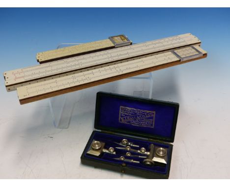 A FABER CASTELL SLIDE RULE TOGETHER WITH TWO OTHERS AND A CASED B J HALL SET OF GEOMETRY DIVIDER ATTACHMENTS.