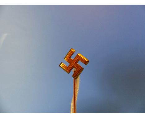 A GILT METAL SWASTIKA STICK PIN.
