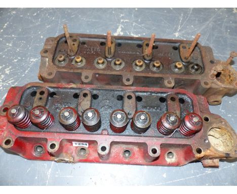TWO BRITISH FOUR CYLINDER ENGINE HEADS, PROBABLY AUSTIN.
