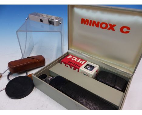 A BOXED MINOX C CAMERA WITH FLASH ATTACHMENT AND INSTRUCTION BOOKLETS TOGETHER WITH ANOTHER SMALLER MINOX CAMERA IN LEATHER C