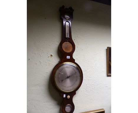 AN AMADIO WALNUT WHEEL BAROMETER, THE BROKEN PEDIMENT ABOVE DRY/DAMP DIAL, MERCURY THERMOMETER, CONVEX MIRROR, THE SILVERED D