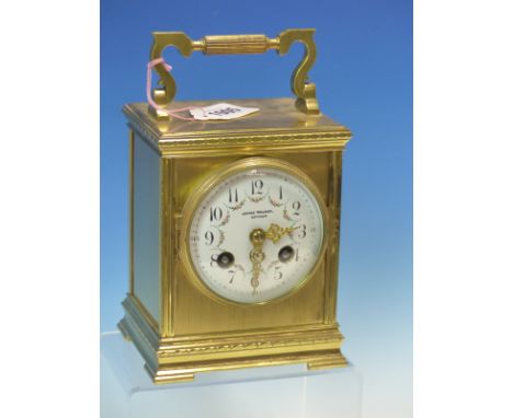 A FRENCH GLAZED BRASS MANTEL CLOCK RETAILED BY JAMES WALKER, THE FLORAL SWAGGED DIAL WITH ARABIC NUMERALS THE MOVEMENT STRIKI