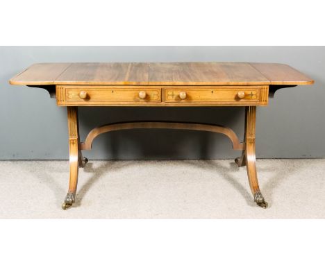 A George III Rosewood and Brass Inlaid Sofa Table, with figured veneered top  and D-shaped flaps, fitted two real drawers to 