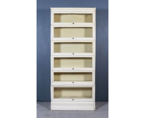 A Globe Wernicke Cream Painted Six-Tier Sectional Bookcase, each tier with a glazed rising front, on plinth base, 34ins wide 