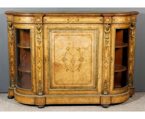 A Victorian Figured Walnut and Gilt Brass Mounted Credenza, with bowed ends, the whole with bead and leaf pattern mouldings a