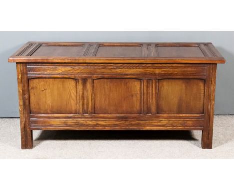 A Panelled Oak Coffer of "17th Century" Design, with moulded and chamfered rails, with three-panel lid and front, 50ins wide 