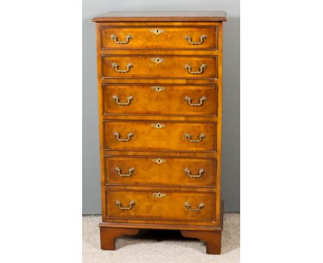 A 20th Century Walnut Chest of "18th Century" Design, the crossbanded top with moulded edge, fitted seven long drawers with c