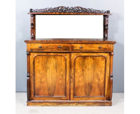 A William IV Rosewood Chiffonier, the upper part with tray top shelf with fretted and carved back, on twin scroll supports an