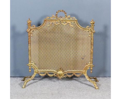 A Gilt Metal Framed and Mesh Fireguard, of Neo-Classical design, with wreath and ribbon cresting, flaming torch uprights on t