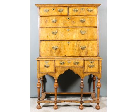 A Late 17th Century Walnut Chest on Stand of William &amp; Mary Design, the matched veneered drawer fronts inlaid with herrin