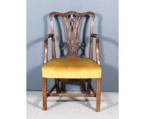 A Mahogany Armchair of "Country Chippendale" Design, with shaped crest rail, fretted splat, seat upholstered in old gold dral