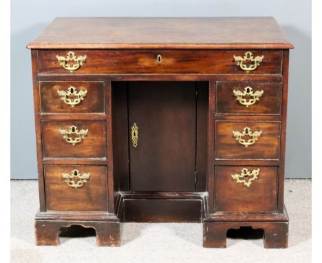 A George III Lady's Mahogany Kneehole Dressing Table, with moulded edge to top, fitted one frieze drawer above recessed cupbo