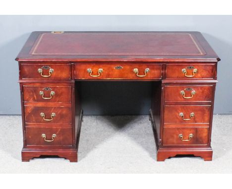 A Modern Mahogany Kneehole Desk, with red leather inset to top and moulded edge, fitted three frieze drawers, one pedestal fi