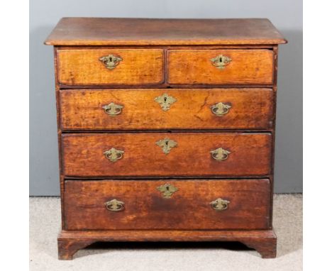 An 18th Century Oak Chest, with moulded edge to top and rounded front corners, fitted two short and three long drawers with o