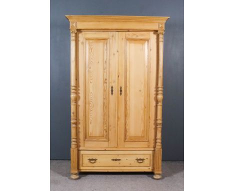 A 19th Century Eastern European Stripped Pine Dwarf Armoire, with moulded cornice, now fitted with a hanging rail enclosed by