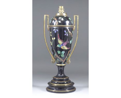 A Gilt Metal Mounted English Pottery Oil Lamp, Late 19th Century, enamelled with bird and butterfly amongst flowering stems o