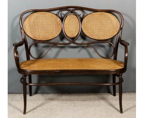 An Austrian Bentwood and Cane Panel Three Seat Settee, by Jacob &amp; Josef Kohn of Wsetin, Austria, the shaped back with thr