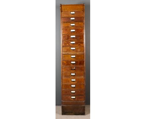 A 1920's Globe Wernicke Oak Tall Filing Chest, with panelled sides, fitted with a brushing slide and fifteen drawers, 17.5ins