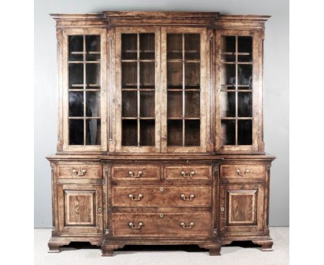 A Modern Oak Breakfront Bookcase of "18th Century" Design, with fluted quarter columns, the upper part with moulded cornice, 