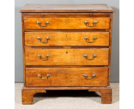 A George III Mahogany Chest, with moulded edge to top, fitted with a brushing slide and four long graduated drawers with bras