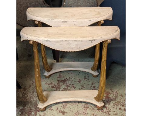 CONSOLE TABLES, a pair, each 79cm W x 27cm D x 74cm H, Art Deco demi lune in a distressed gilt and cream painted finish. (2) 