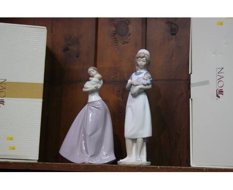 Two boxed Nao figures