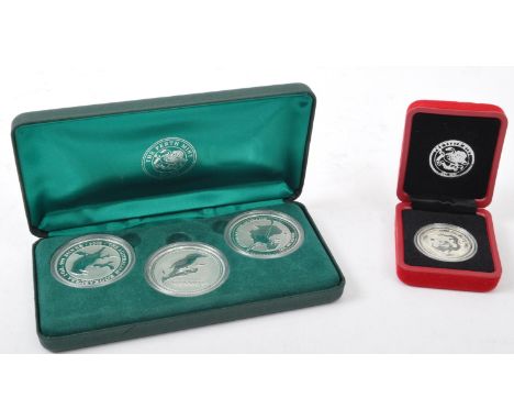 A 2002, 2003, 2004 Australia set of three 1Oz 999 silver Kookaburra $1 dollar coin set. Together with a 2000 Japanese 999 1/2