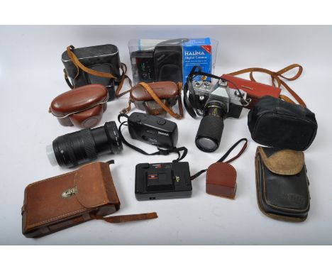 An assortment of retro vintage 20th century camera equipment. The lot to include a Zenit EM camera, a Kodak Colorsnap 35 came