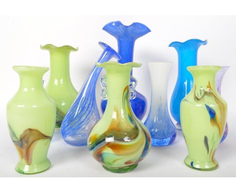 An assortment of vintage 20th century studio art glass items. The lot to include a set of opaque light green vases of various