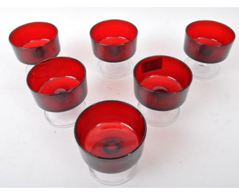 A collection of vintage 20th Century French stemmed ice cream bowls / champagne glasses. In a red ground circular receptacles