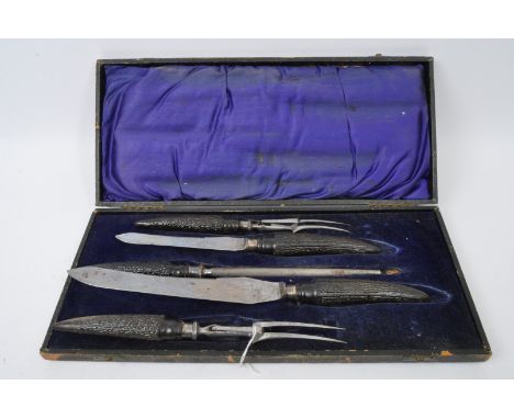 An early 20th century circa. 1920's hallmarked silver and bone handled meat serving set within leather case lined with navy b