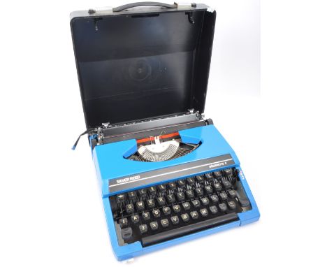 A vintage 20th century Silver Reed typewriter in black and blue colourway. Measures 31cm length.