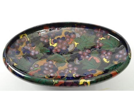 An early 20th century Royal Stanley Ware 'Jacobea' ceramic centrepiece fruit bowl with grape decorations in dark blues &amp; 