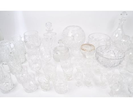 A large collection of vintage 20th century cut glass items. The lot to include decanters, an oversized lidded bonbon dish, bo