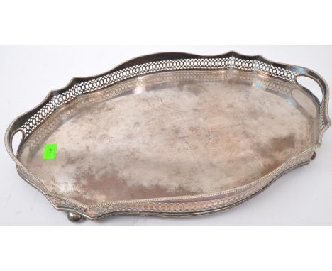 A large early 20th Century silver plated serving centre piece tray. Having a surrounded pierced gallery, twin handles support